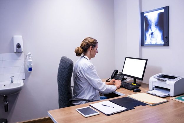 nurse-using-desktop-and-printer